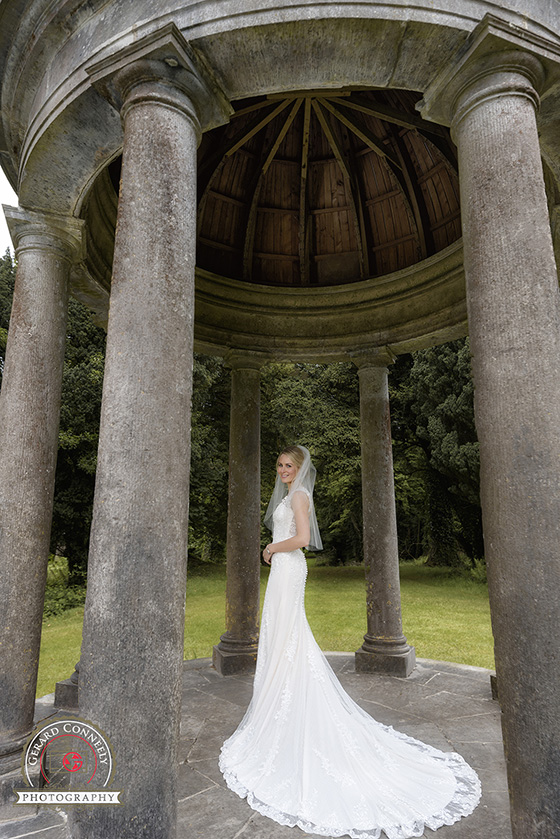 Bride at the temple of mercury at Dromoland Castle on her wedding day